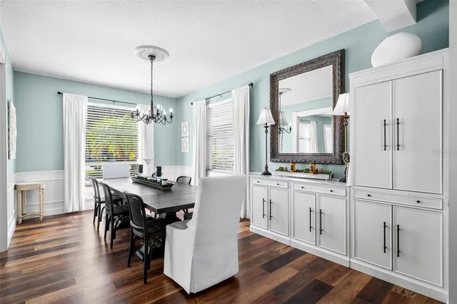 a dining room with furniture wooden floor and a flat screen tv