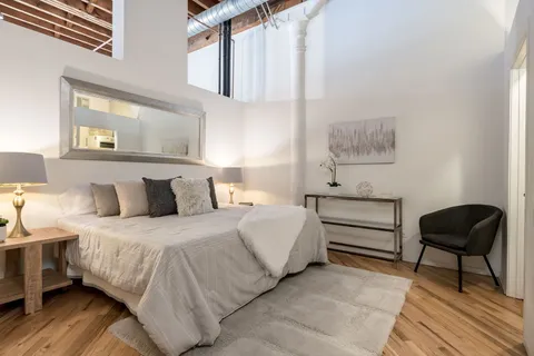 a bedroom with double bed and a window