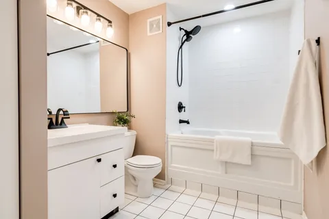 a bathroom with a sink a toilet and a bathtub