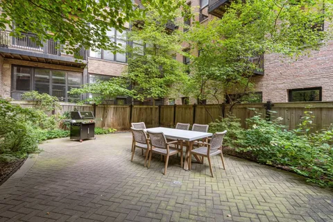 a view of a patio with table and chairs and potted plants