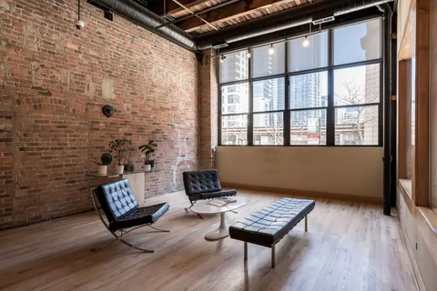 a living room with furniture wooden floor and a window