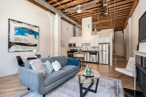 a living room with furniture and wooden floor