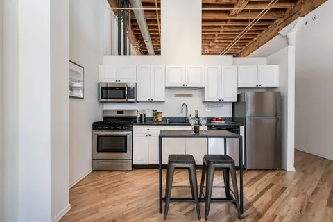 a kitchen with stainless steel appliances a refrigerator and a stove top oven