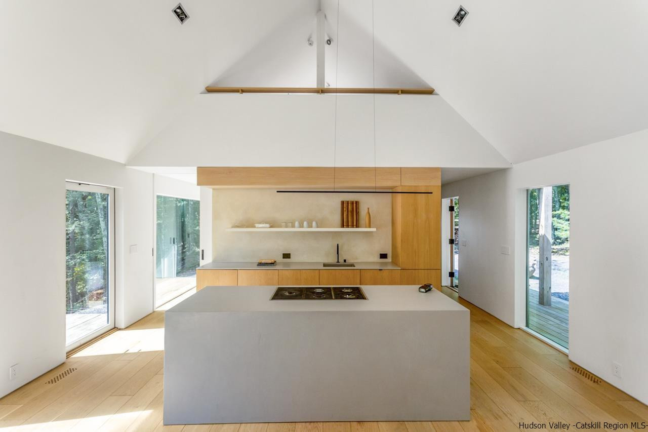 261 Blackhead Mountain Round Top, NY 12473 - Photo 11 of 34 a bedroom with a bed and large window