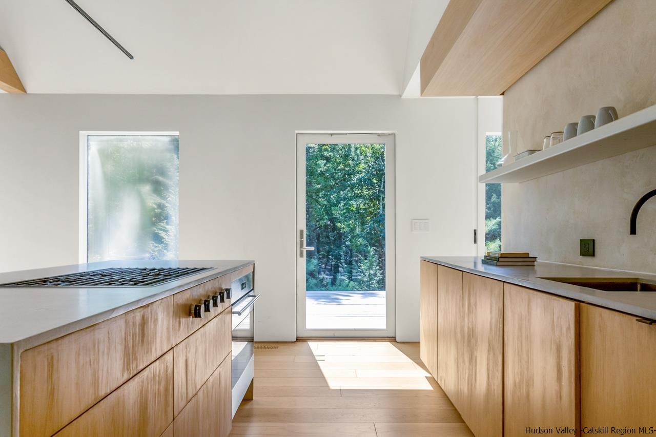 261 Blackhead Mountain Round Top, NY 12473 - Photo 13 of 34 a kitchen with granite countertop a sink and a stove