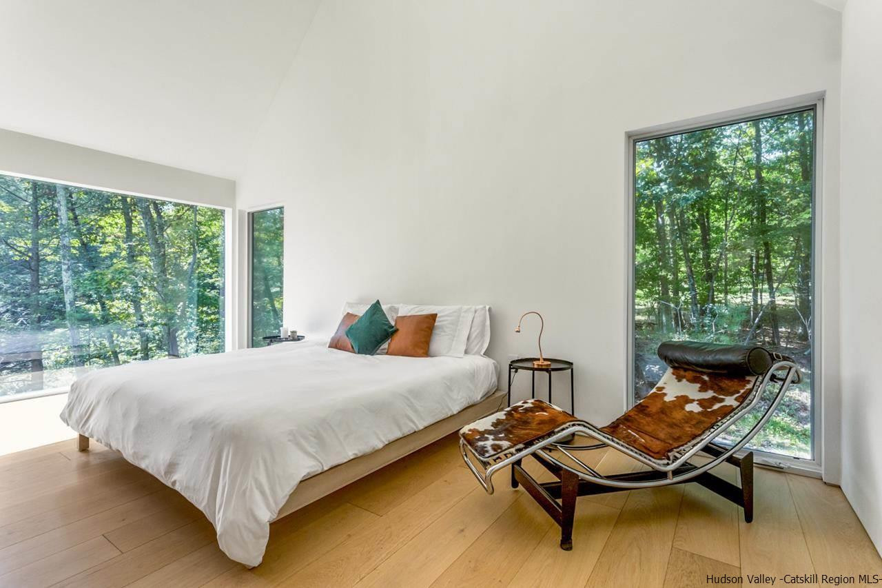 261 Blackhead Mountain Round Top, NY 12473 - Photo 15 of 34 a bedroom with a bed and wooden floor