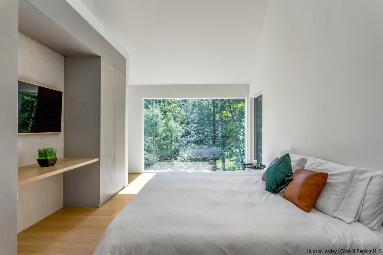 261 Blackhead Mountain Round Top, NY 12473 - Photo 16 of 34 a bed room with a bed a television and a window