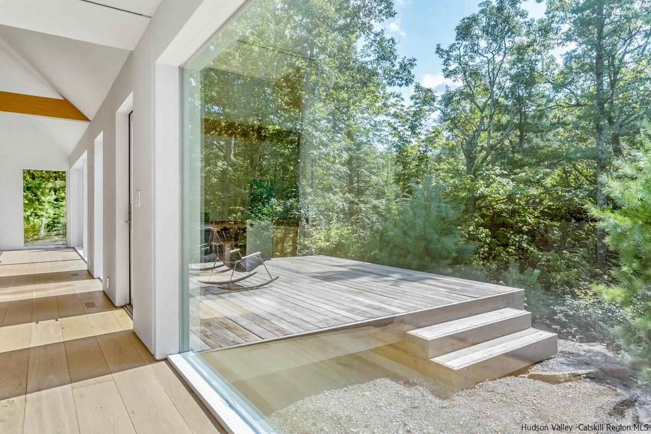 261 Blackhead Mountain Round Top, NY 12473 - Photo 17 of 34 a view of a balcony and floor to ceiling windows
