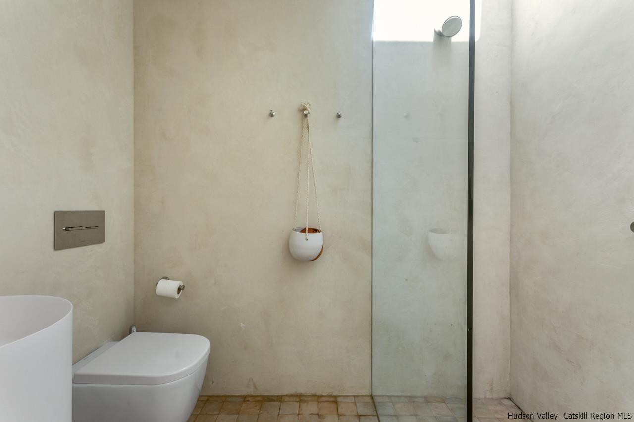 261 Blackhead Mountain Round Top, NY 12473 - Photo 20 of 34 a bathroom with a granite countertop toilet and a shower