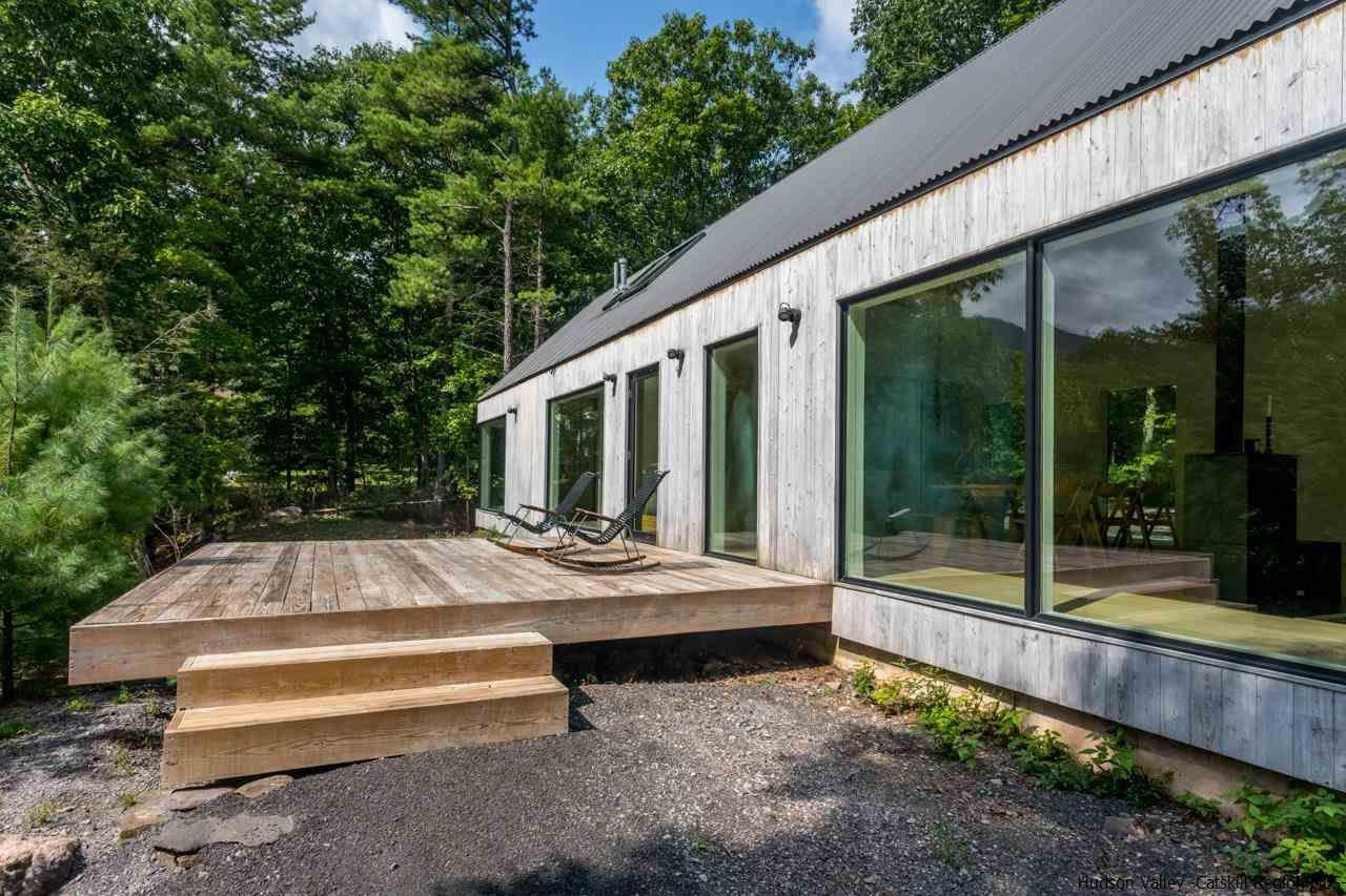 261 Blackhead Mountain Round Top, NY 12473 - Photo 28 of 34 a view of patio with table and chairs and floor to ceiling window and plants
