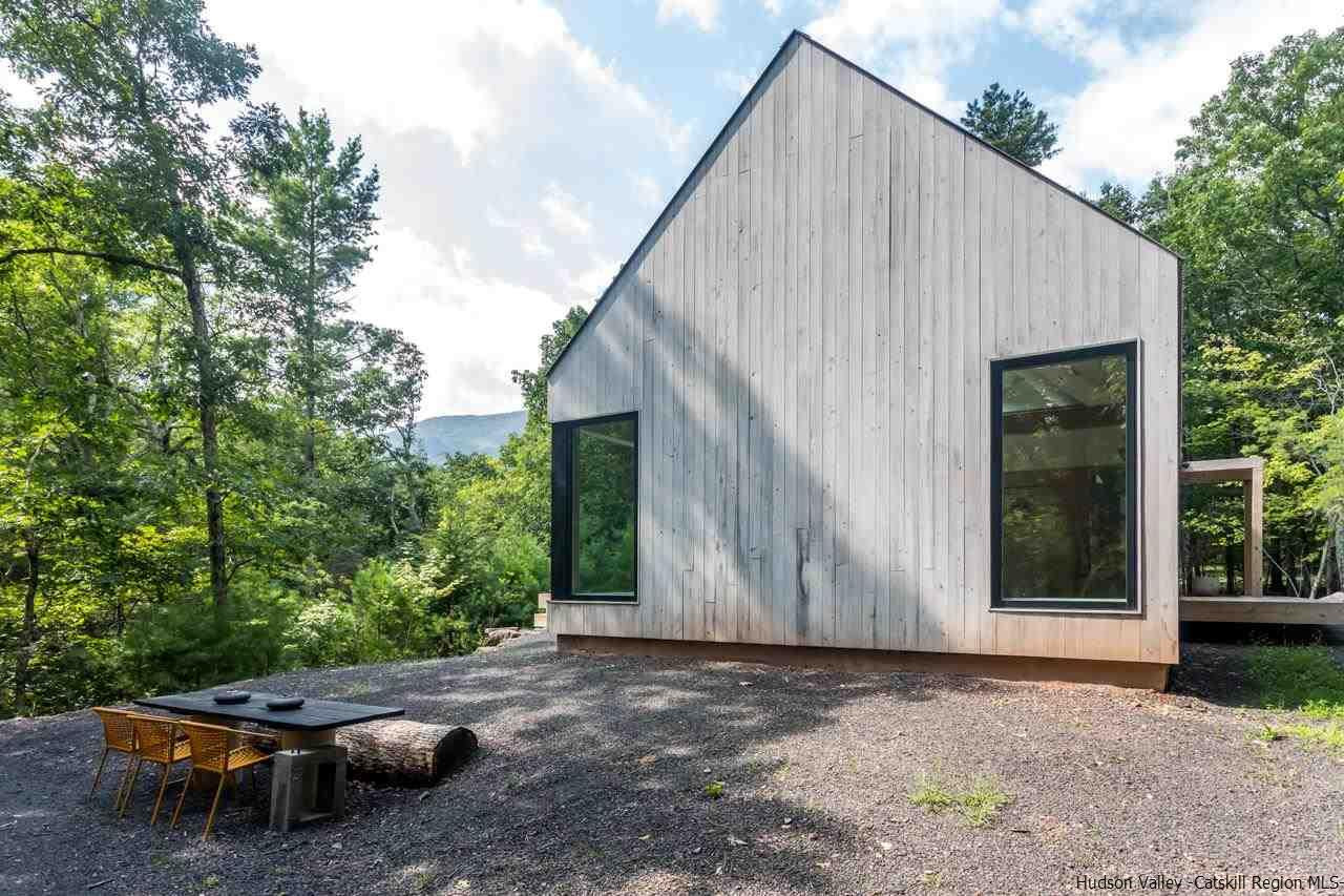 261 Blackhead Mountain Round Top, NY 12473 - Photo 30 of 34 a backyard of a house with lawn chairs plants and large tree