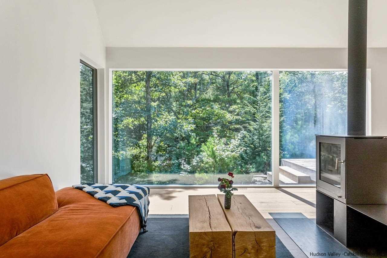 261 Blackhead Mountain Round Top, NY 12473 - Photo 7 of 34 a living room with furniture and a flat screen tv
