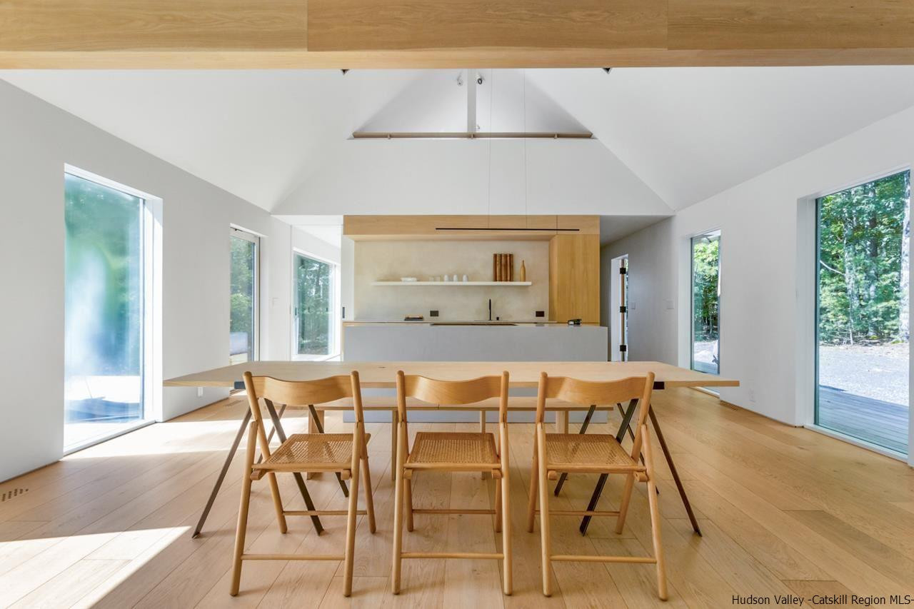 261 Blackhead Mountain Round Top, NY 12473 - Photo 9 of 34 a view of a dining room with furniture and wooden floor