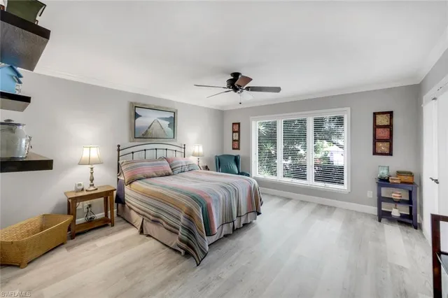 a spacious bedroom with a bed and a large window