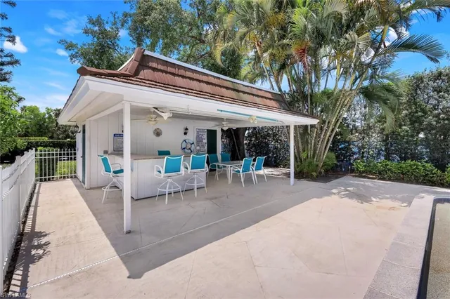 a view of a patio with couches table and chairs and potted plants