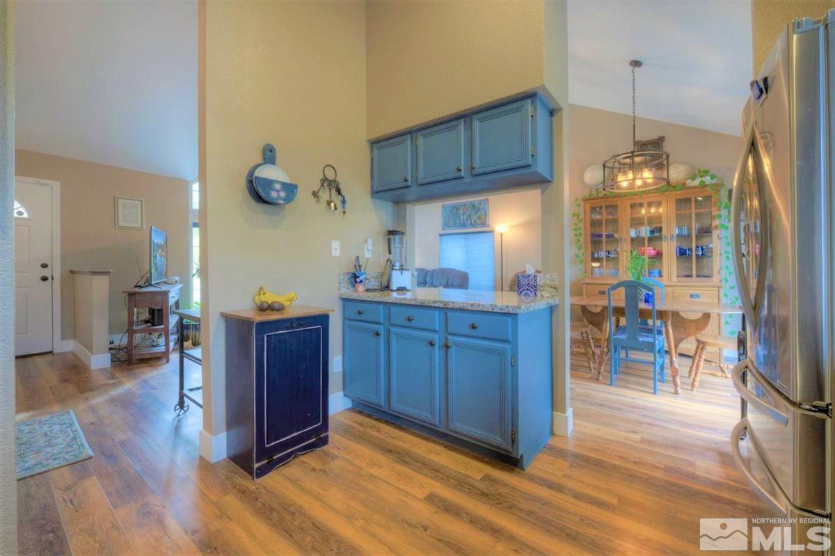 15135 Sylvester Road Reno, NV 89521 - Photo 11 of 34 a kitchen with stainless steel appliances granite countertop a refrigerator a sink and a wooden cabinets