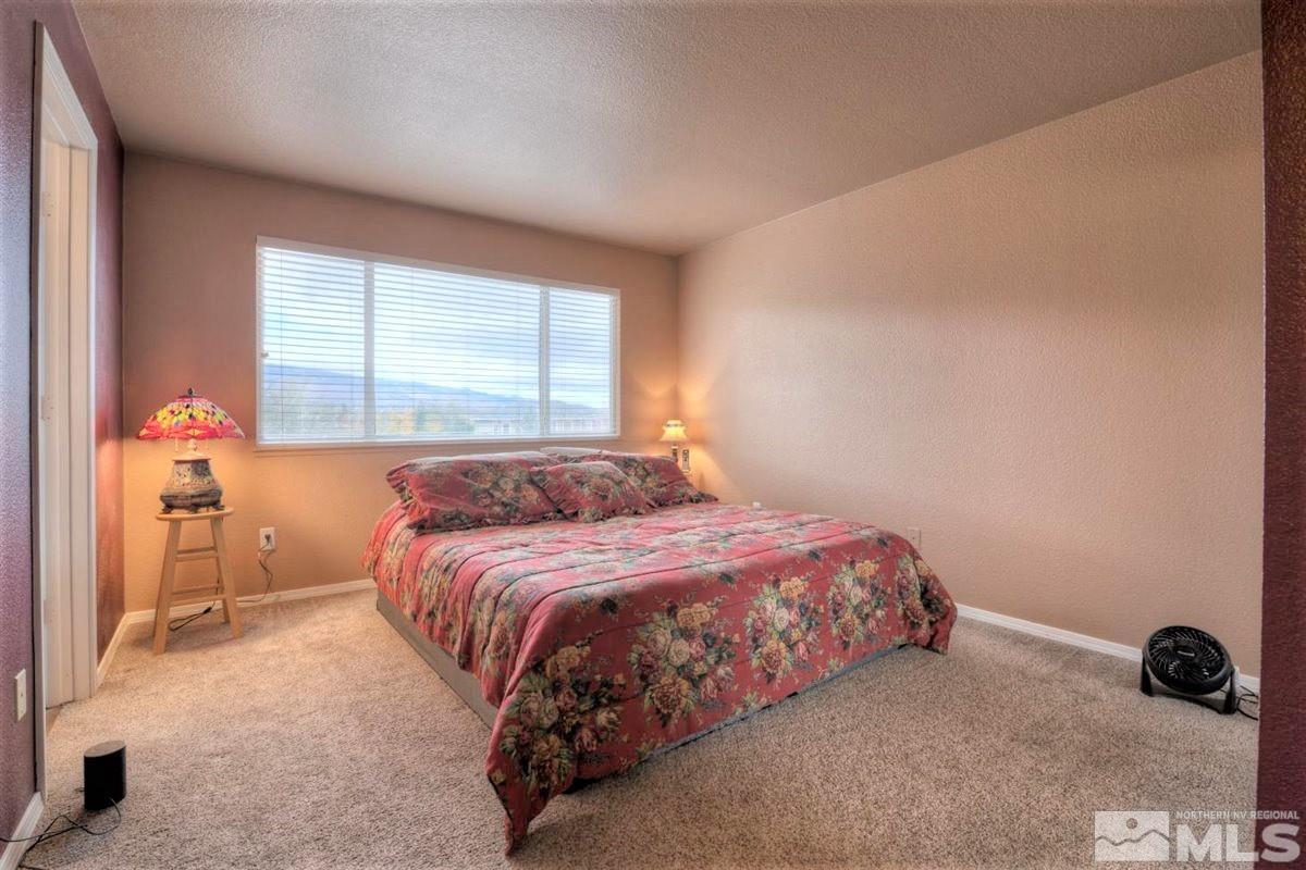 15135 Sylvester Road Reno, NV 89521 - Photo 15 of 34 a bedroom with a bed and a window