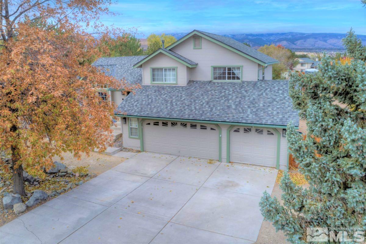 15135 Sylvester Road Reno, NV 89521 - Photo 2 of 34 a front view of a house with yard and trees