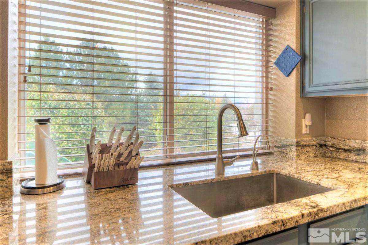 15135 Sylvester Road Reno, NV 89521 - Photo 10 of 34 a kitchen with granite countertop a sink and a window