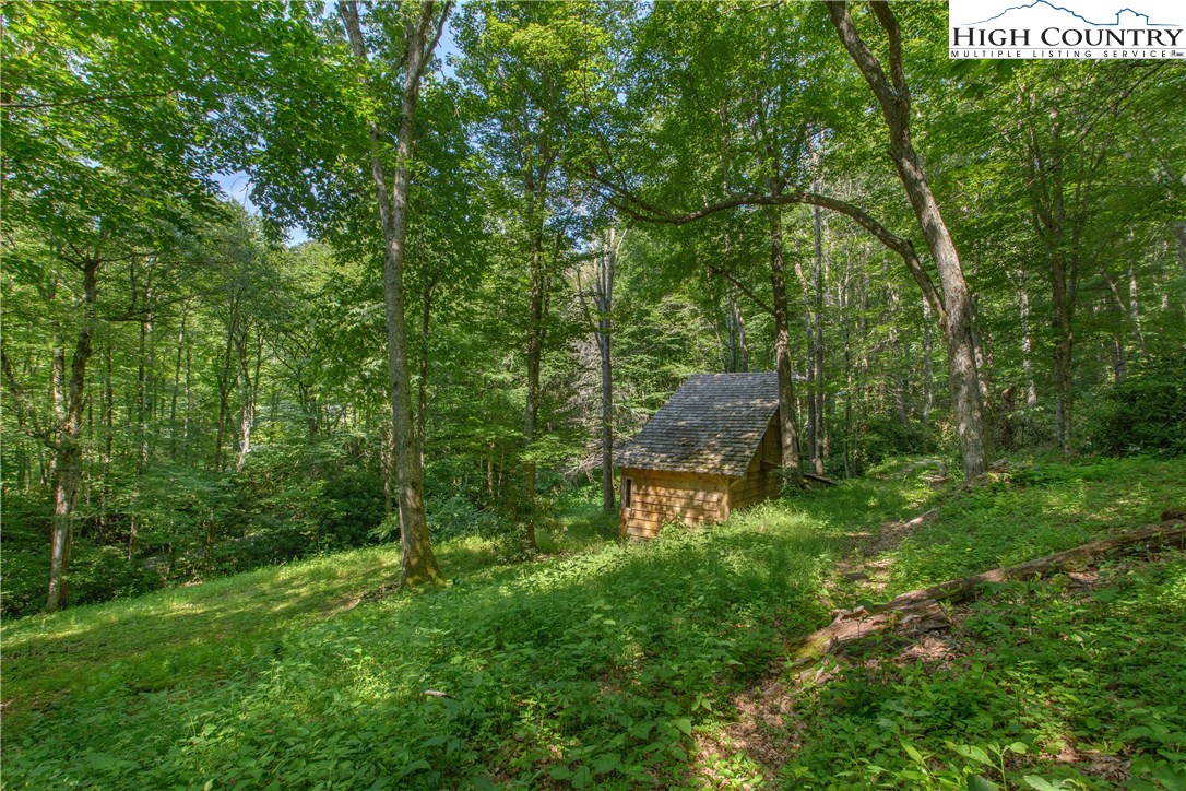 35 Beagle Road Newland, NC 28657 - Photo 17 of 17 a backyard of a house with outdoor seating and green space