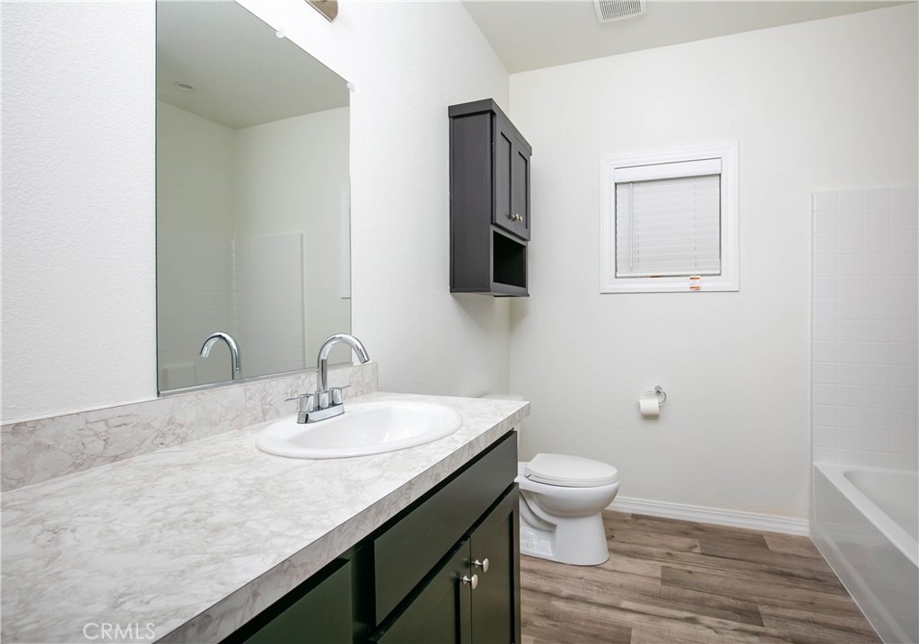 657 Lebec Road, Unit 2 Lebec, CA 93243 - Photo 15 of 17 a bathroom with a granite countertop sink a toilet and a mirror