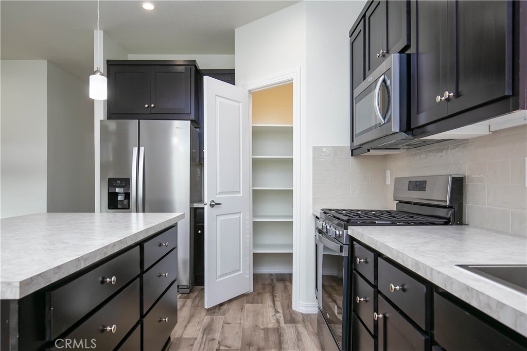 657 Lebec Road, Unit 2 Lebec, CA 93243 - Photo 10 of 17 a kitchen with kitchen island granite countertop a sink cabinets and stainless steel appliances