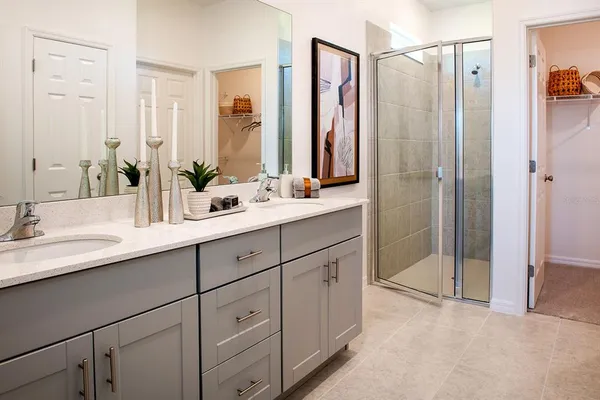 a bathroom with double sink and a mirror