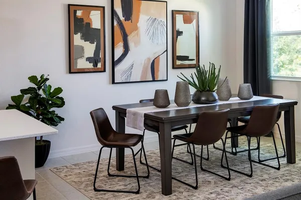a view of a dining room with furniture and a potted plant