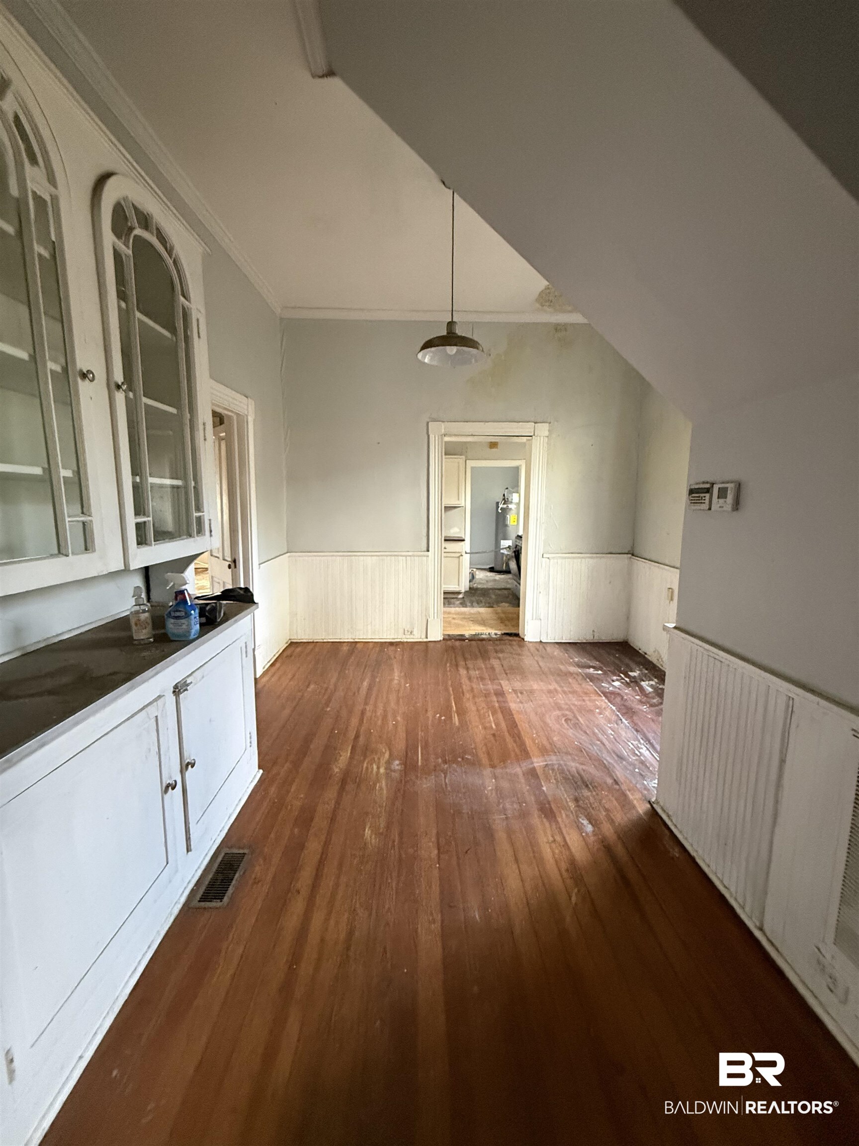 352 South Ann Street Mobile, AL 36604 - Photo 5 of 20 Unfurnished dining area with dark wood-type flooring, a wainscoted wall, and ornamental molding