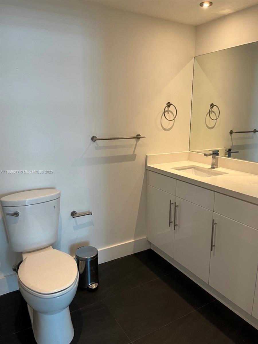 1250 South Miami Avenue, Unit 1414 Miami, FL 33130 - Photo 19 of 25 a bathroom with a toilet sink and mirror