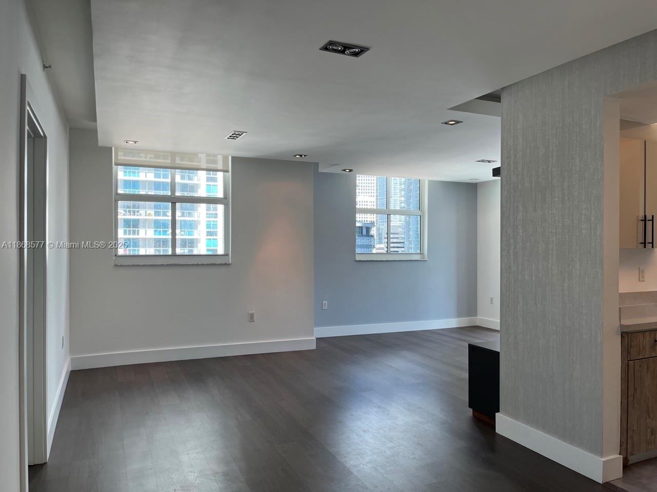 1250 South Miami Avenue, Unit 1414 Miami, FL 33130 - Photo 2 of 25 an empty room with wooden floor and windows