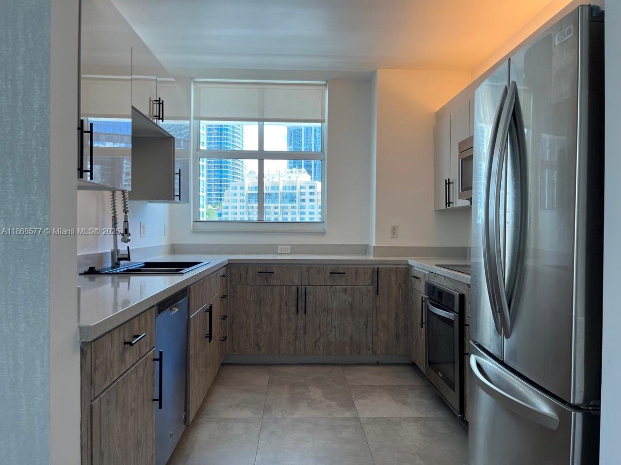 1250 South Miami Avenue, Unit 1414 Miami, FL 33130 - Photo 3 of 25 a kitchen with stainless steel appliances granite countertop a sink stove and refrigerator