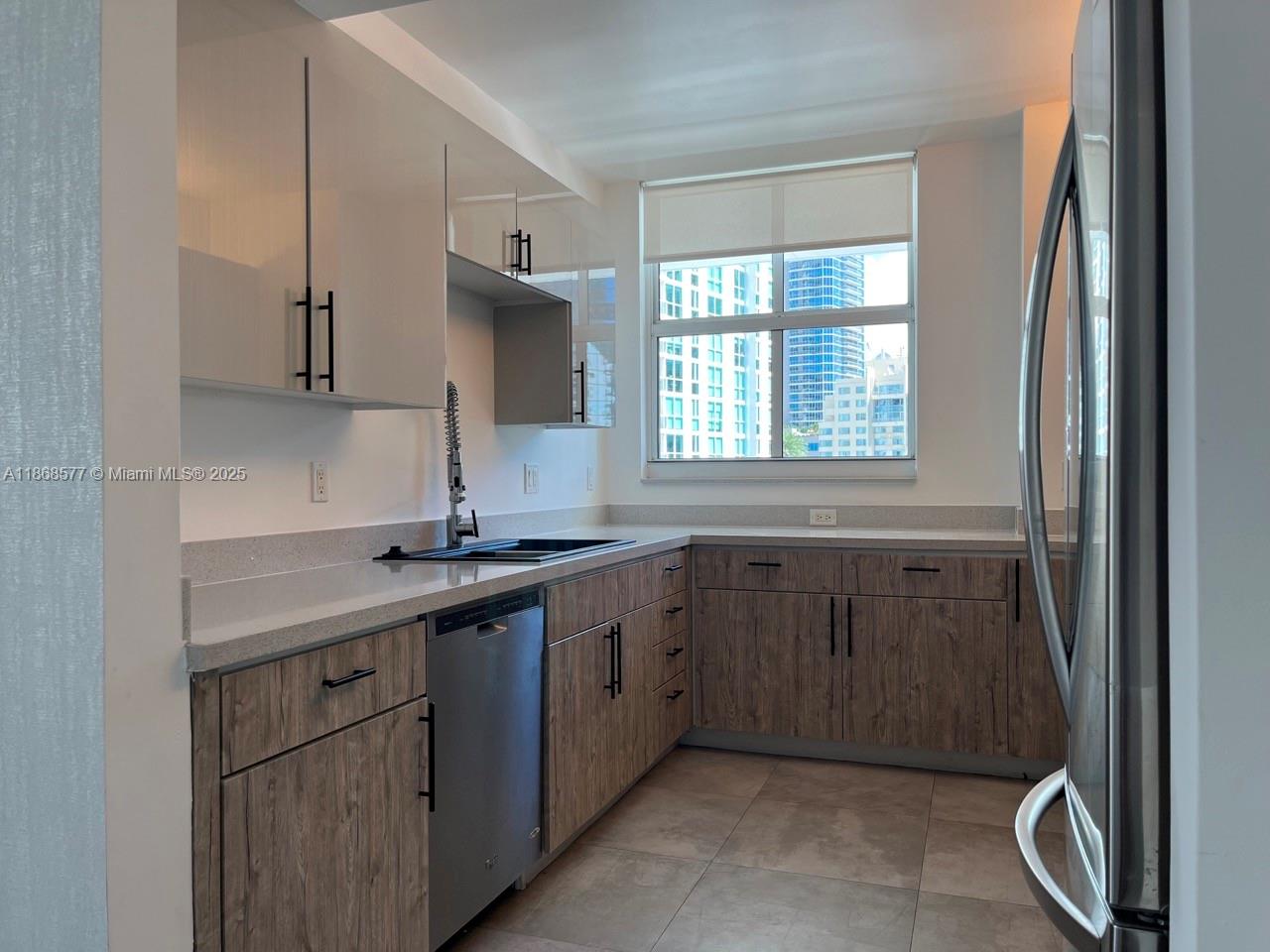 1250 South Miami Avenue, Unit 1414 Miami, FL 33130 - Photo 4 of 25 a kitchen with a sink stove and cabinets