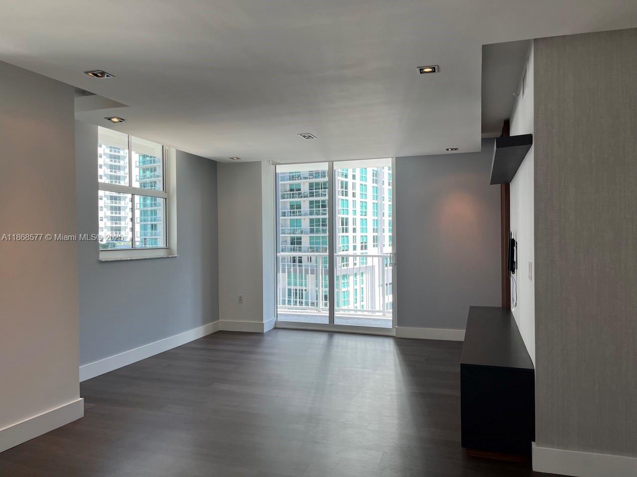 1250 South Miami Avenue, Unit 1414 Miami, FL 33130 - Photo 5 of 25 a view of an empty room with wooden floor and a window