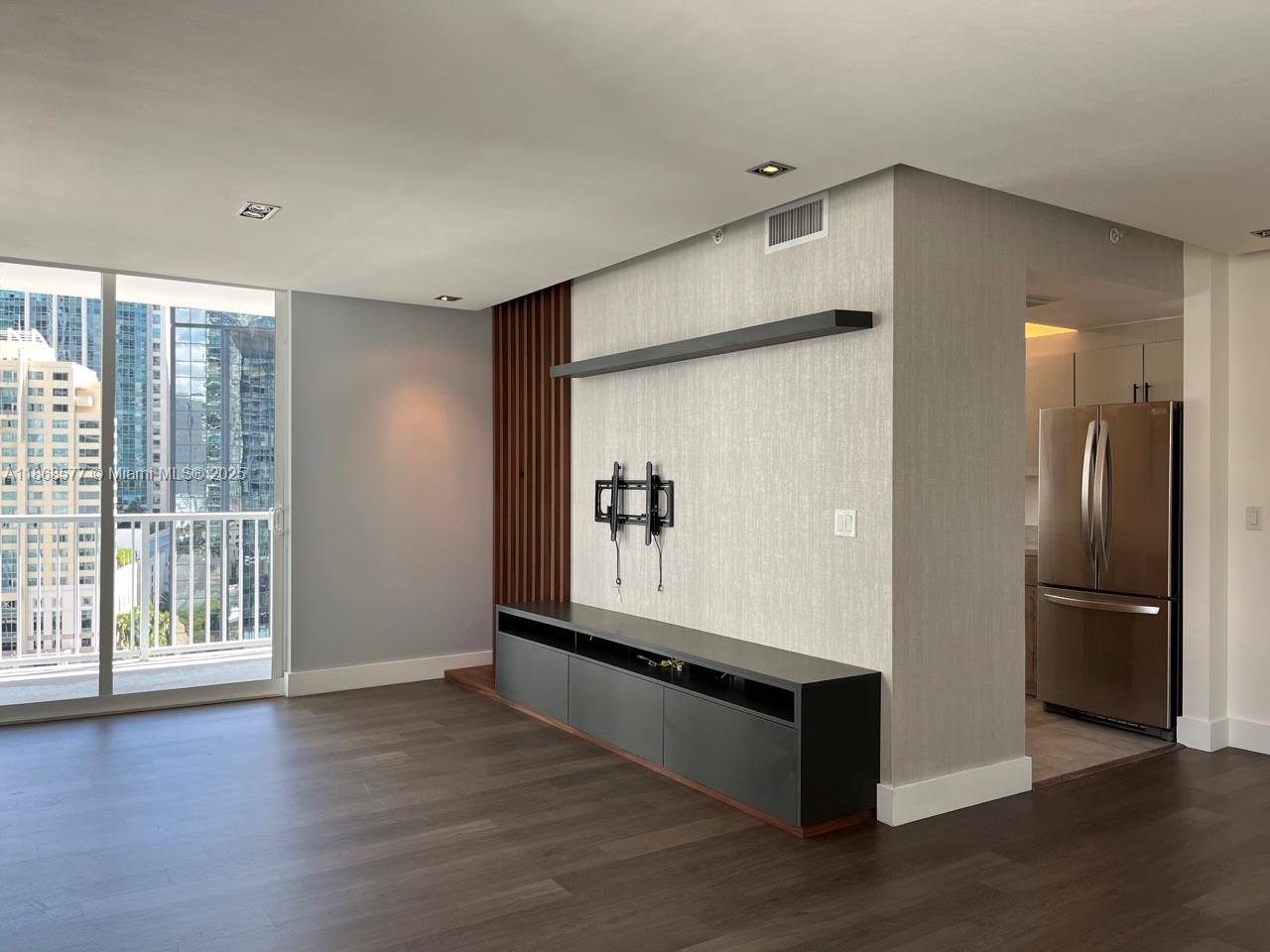 1250 South Miami Avenue, Unit 1414 Miami, FL 33130 - Photo 6 of 25 a view of an empty room with wooden floor and a window