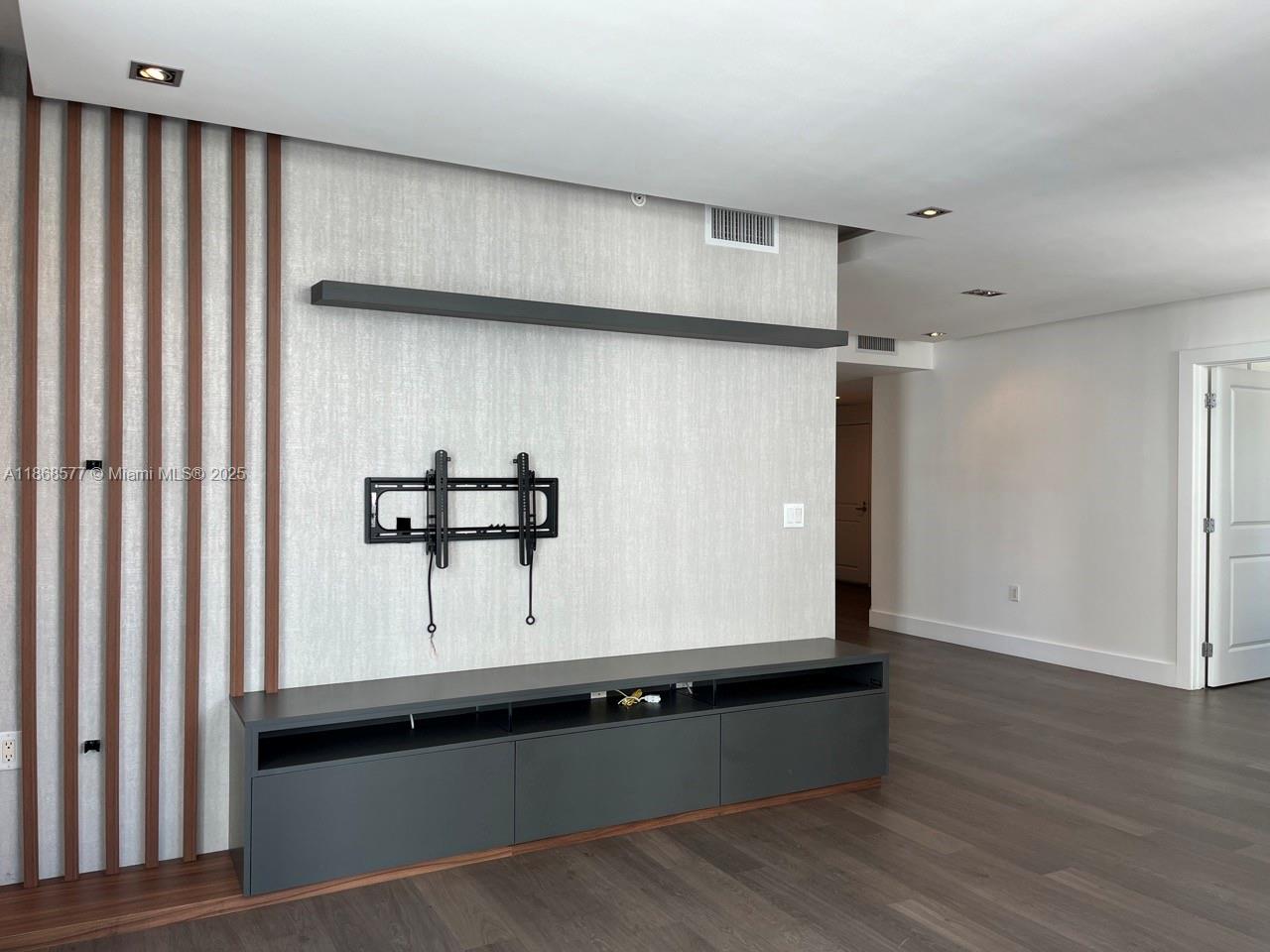 1250 South Miami Avenue, Unit 1414 Miami, FL 33130 - Photo 7 of 25 a view of an empty room with wooden floor and a window