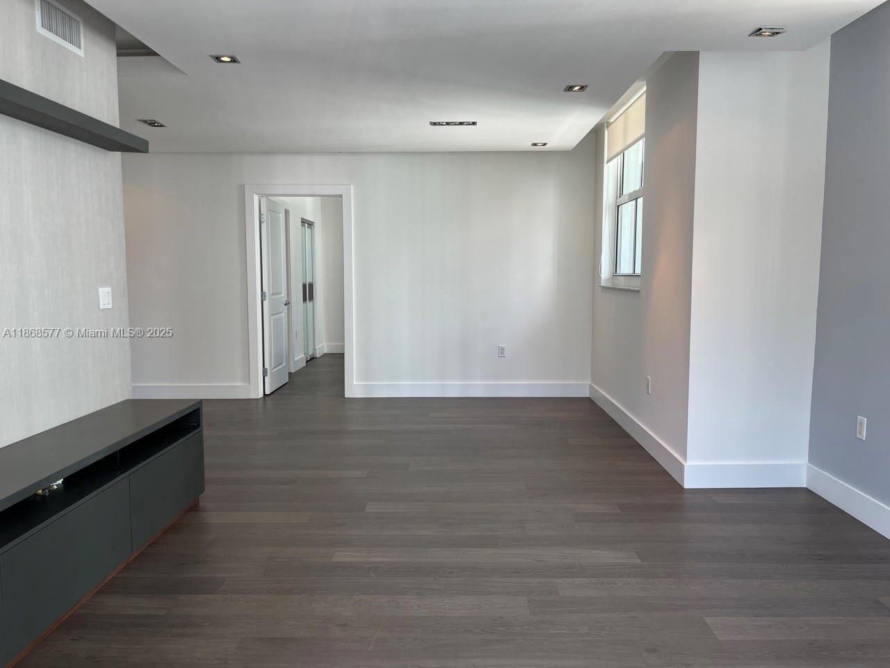 1250 South Miami Avenue, Unit 1414 Miami, FL 33130 - Photo 8 of 25 a view of an empty room with wooden floor and a window