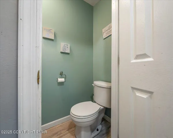 a white toilet sitting next to a bathroom sink and vanity