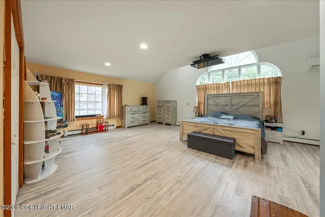 a bedroom with a large bed and a chandelier