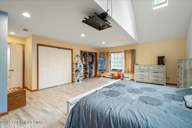 a bedroom with a bed and a chandelier