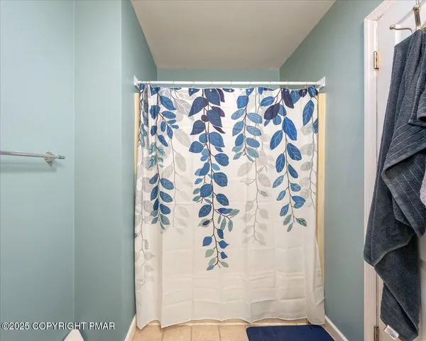 a spacious bedroom with a bed and a chandelier