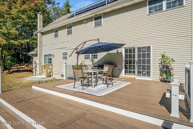 a view of a patio with table and chairs and potted plants
