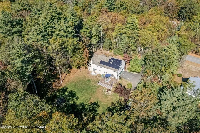an aerial view of residential house with outdoor space