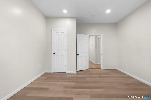 an empty room with wooden floor