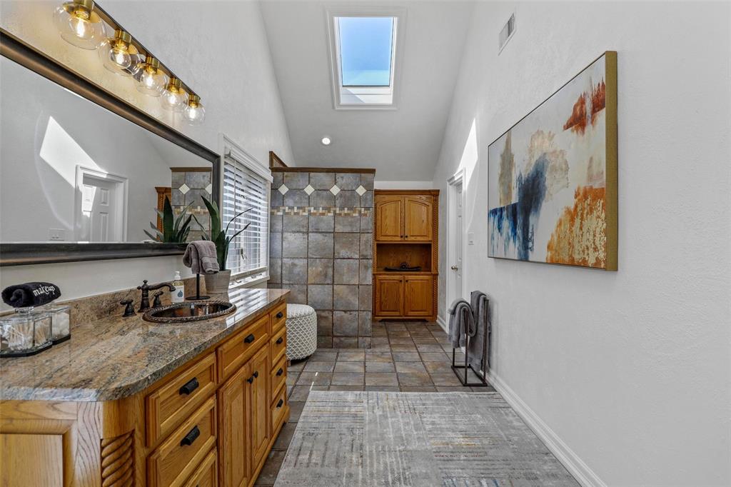 2243 Wood Hollow Road Denton, TX 76208 - Photo 30 of 40 Primary bath with vaulted ceiling with skylight