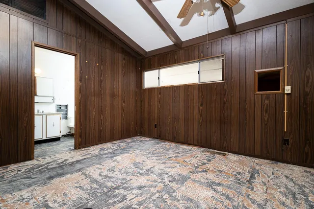 a view of a big room with wooden floor closet and windows
