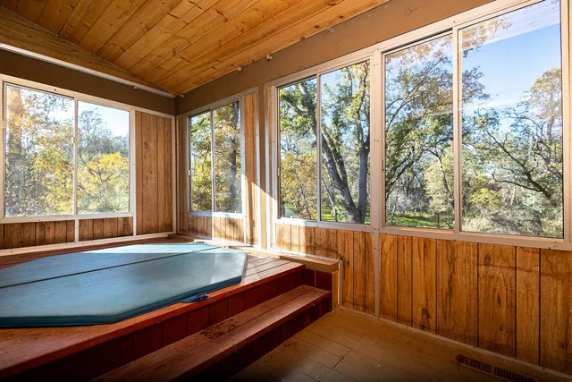 a view of a room with wooden floor and outdoor view