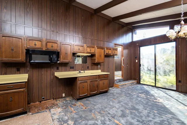 a kitchen with sink cabinets and appliances