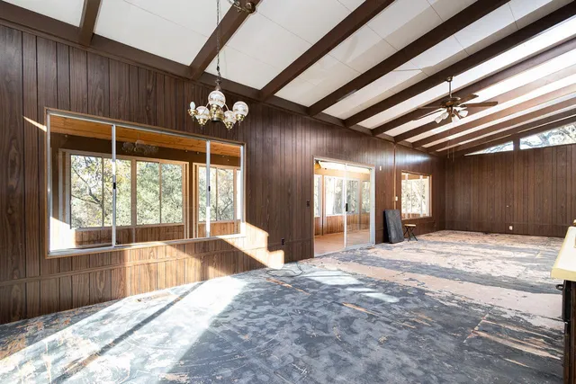 a spacious bedroom with a large bed and a large window