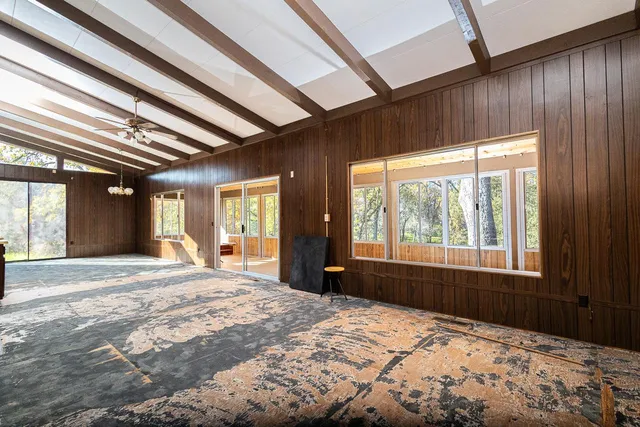 a bedroom with a bed and a large window